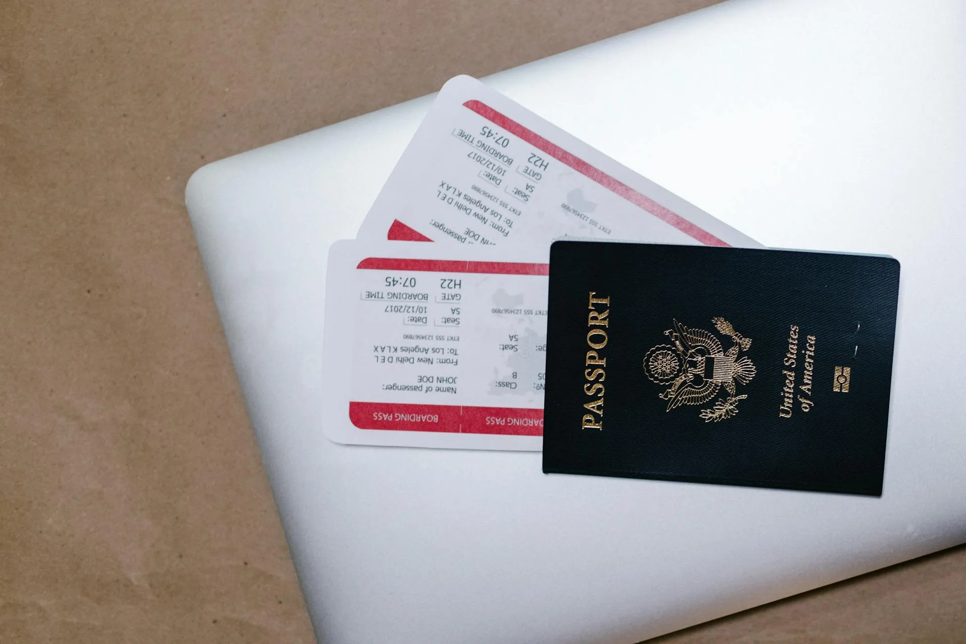 Passport and boarding passes on a laptop before a trip