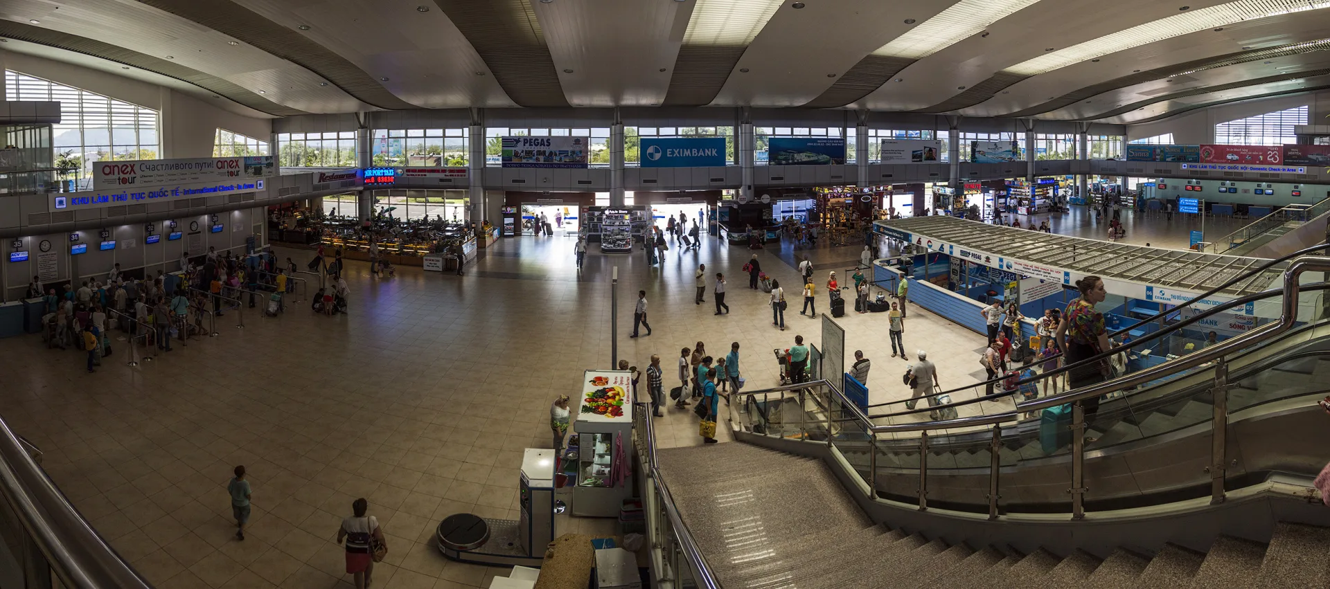 Cam Ranh airport terminal in Vietnam with passengers and luggage